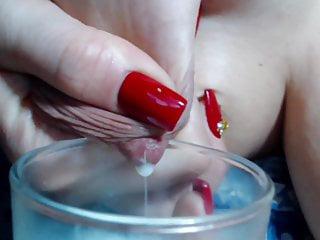 Sie melkt ihre Titten in einem Glas voller Milch